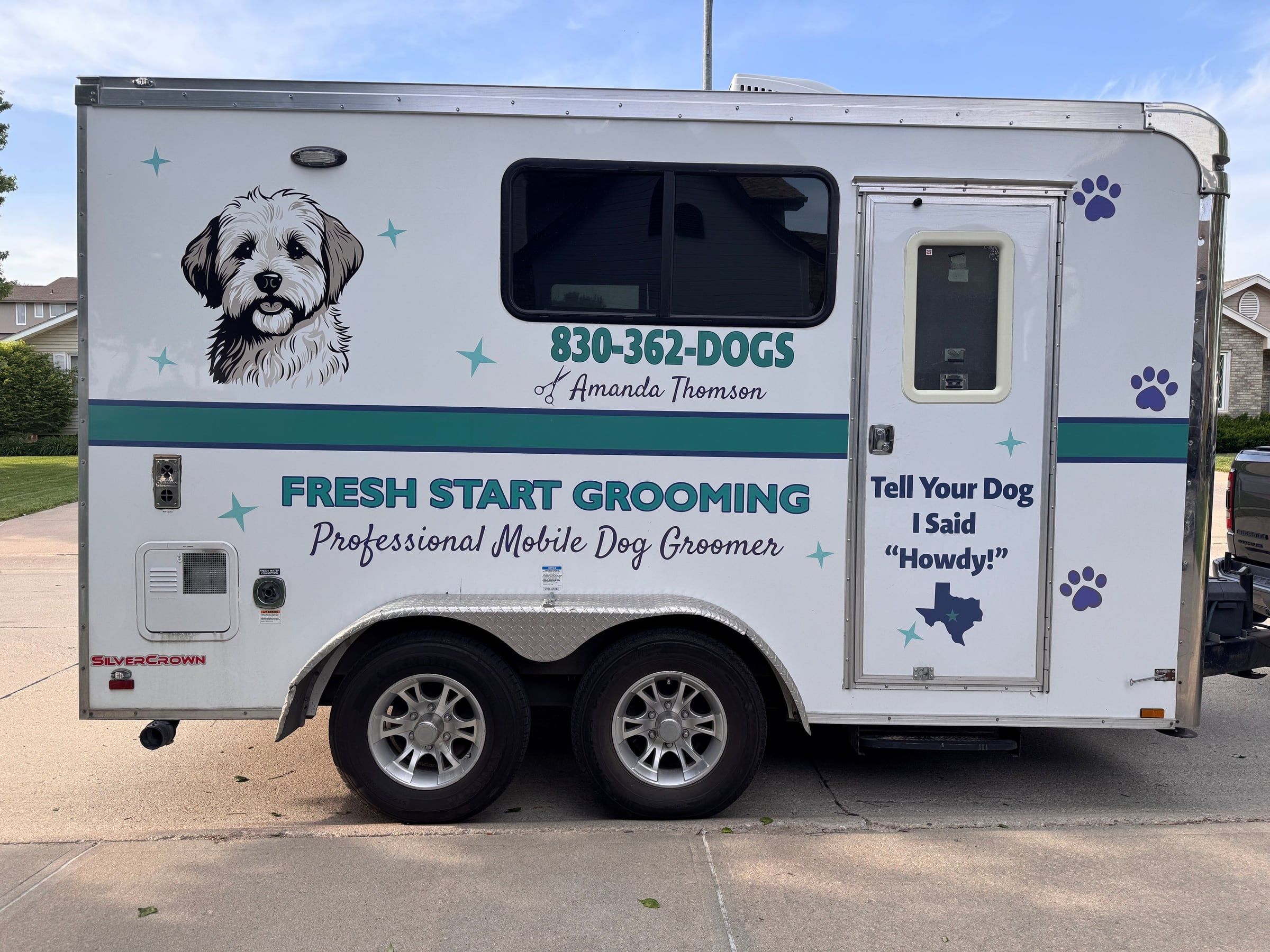 Trailer entry door with the Tell Your Dog I Said Howdy Texas decal